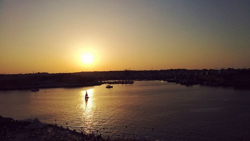 Scenic view of sea against clear sky during sunset