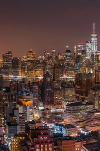 Aerial view of city lit up at night