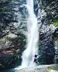 Scenic view of waterfall against sky