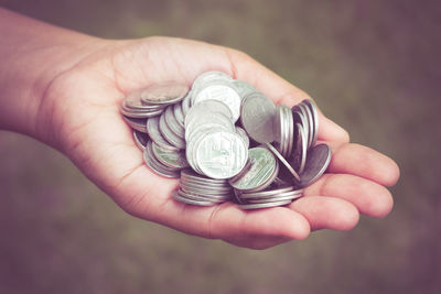 Close-up of hand holding coins