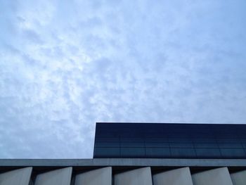 Low angle view of building against cloudy sky