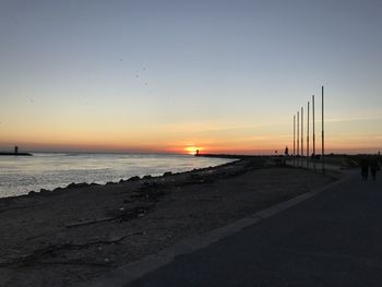 Scenic view of beach against sky during sunset