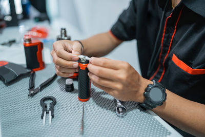 Midsection of man working at workshop