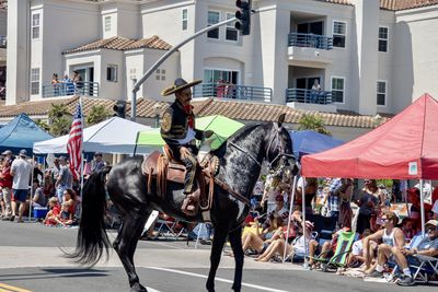 People riding horse in city