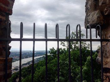 Scenic view of river against cloudy sky