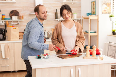 Friends standing on table at home