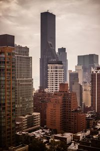 Skyscrapers against cloudy sky