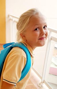 Portrait of smiling girl standing at home