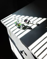 High angle view of guitar on table against black background