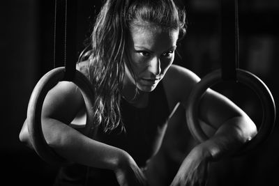 Thoughtful woman doing exercise in darkroom