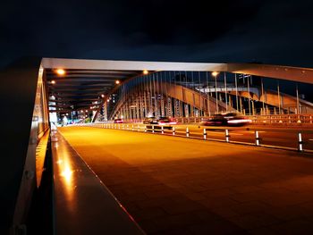 Illuminated bridge against sky in city at night