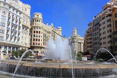 Fountain near plaza ayuntamiento. architecture of the city center.