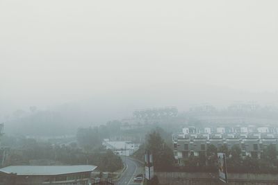 Cityscape against sky during foggy weather