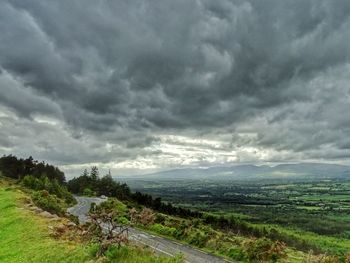 Scenic view of storm clouds over landscape