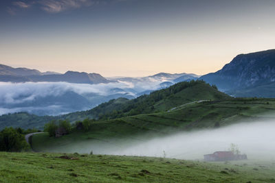 Scenic view of landscape and mountains against sky