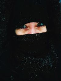 Portrait of beautiful woman against black background