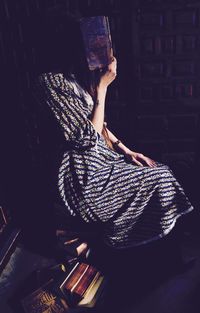 Midsection of woman standing indoors