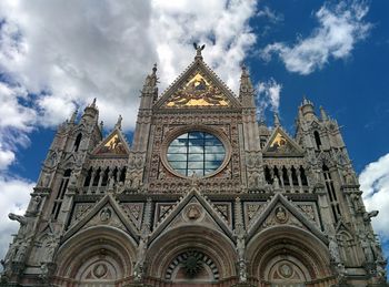 Low angle view of church against cloudy sky