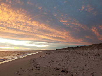 Scenic view of beach against sky during sunset