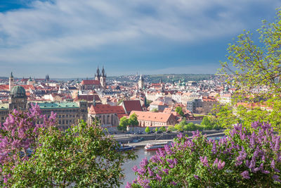 View of buildings in town against cloudy sky