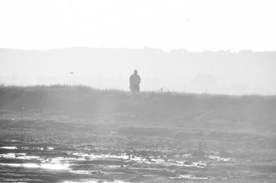 Rear view of silhouette man against sky