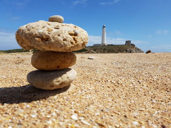 Rocks on beach against sky