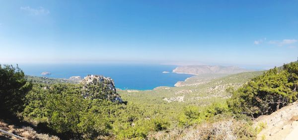 Scenic view of bay against clear blue sky