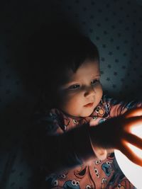 Baby girl playing with illuminated light at home