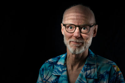 Portrait of mid adult man against black background