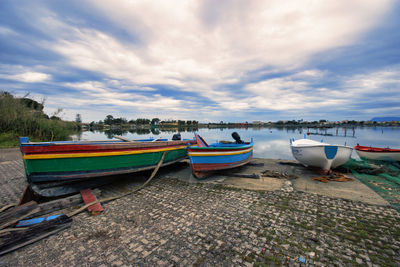 Boats moored on beach against sky