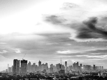 Cityscape against cloudy sky