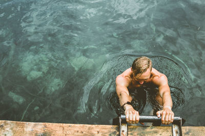 High angle view of shirtless man in swimming pool