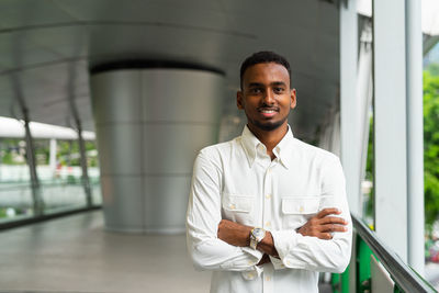 Portrait of young man standing in city