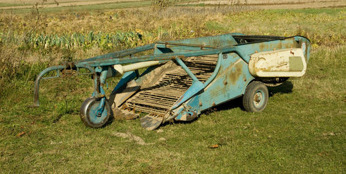 Abandoned vintage car on field