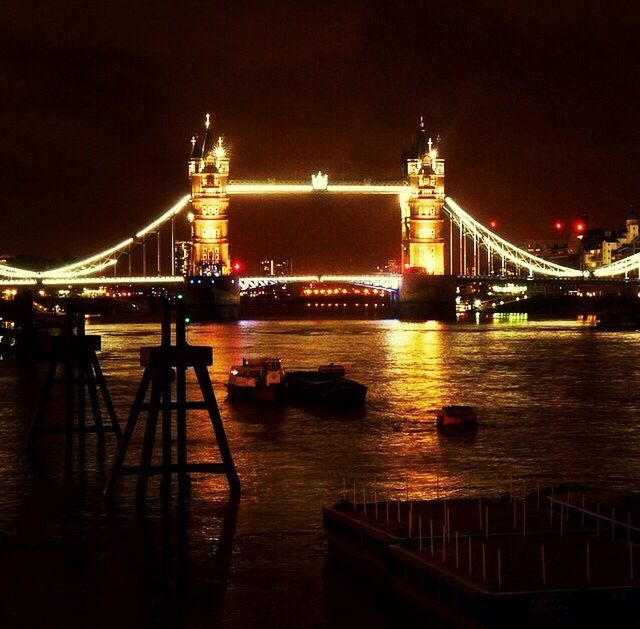 illuminated, night, architecture, built structure, bridge - man made structure, connection, engineering, river, water, suspension bridge, travel destinations, famous place, transportation, international landmark, tourism, travel, bridge, city, waterfront, capital cities