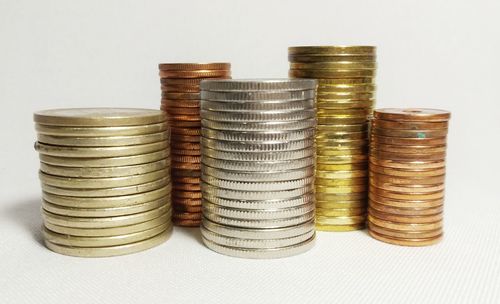 Close-up of coin stack against white background