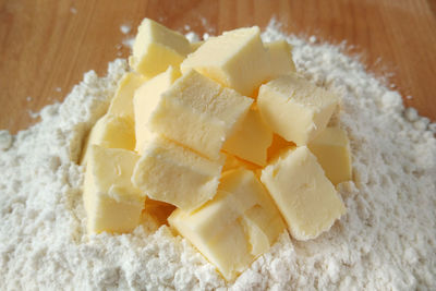 Close-up of flour and butter on wooden table