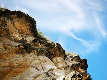 Low angle view of rock formation against sky