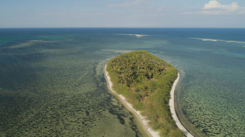 Tropical island with white sandy beach, palm trees. tanduyong island with colorful reef. 