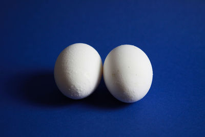 Close-up of eggs against blue background