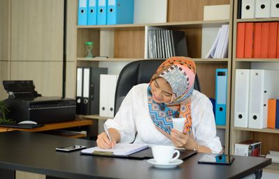Midsection of man working at table