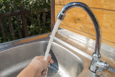 Midsection of woman holding water at home