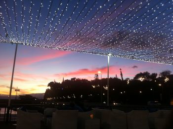 View of illuminated street lights at night