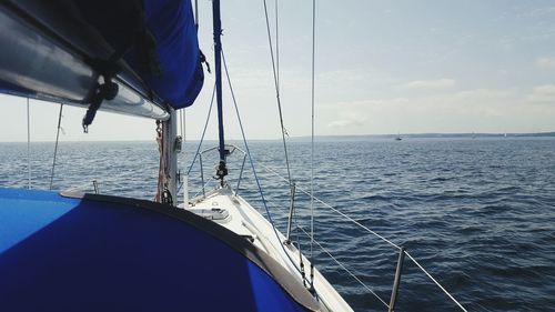 Sailboat sailing on sea against sky