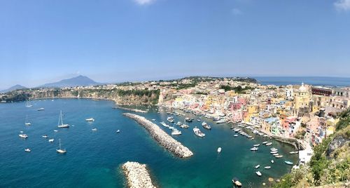 High angle view of city by sea against sky