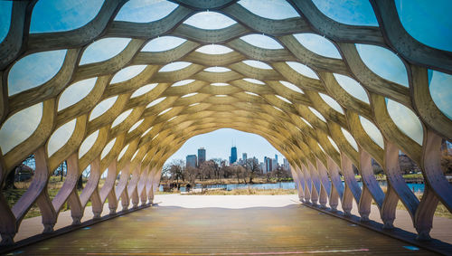 Arch bridge in building against sky