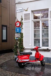 Red motorcycle against brick wall