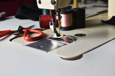 Close-up of sewing machine on table