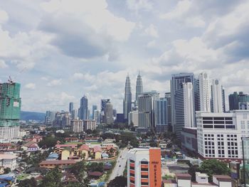 Cityscape against cloudy sky