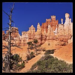 Scenic shot of rock formations against blue sky